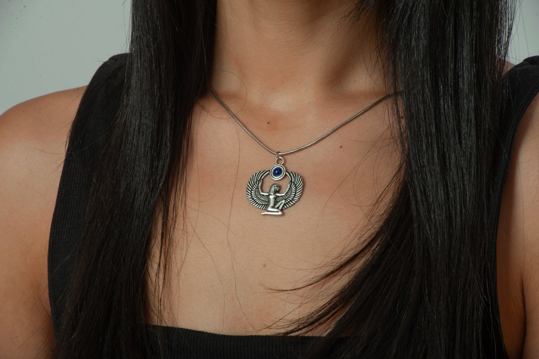 Necklace with a pendant worn by a person with long dark hair.