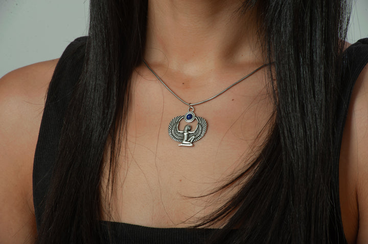 Necklace with a pendant worn by a person with long dark hair.