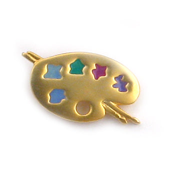 A gold-colored enamel pin shaped like an artist's paint palette, featuring cutouts filled with blue, green, purple, and pink enamel colors, set against a plain white background.