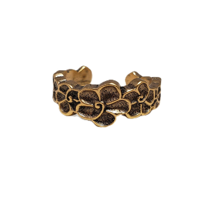 Bronze ring with floral design on a white background