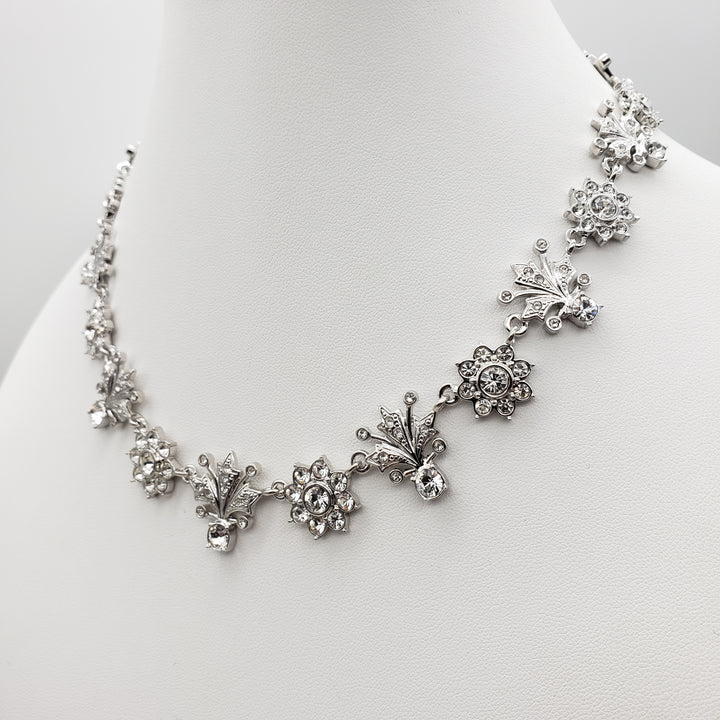 Silver floral bracelet on a white stand