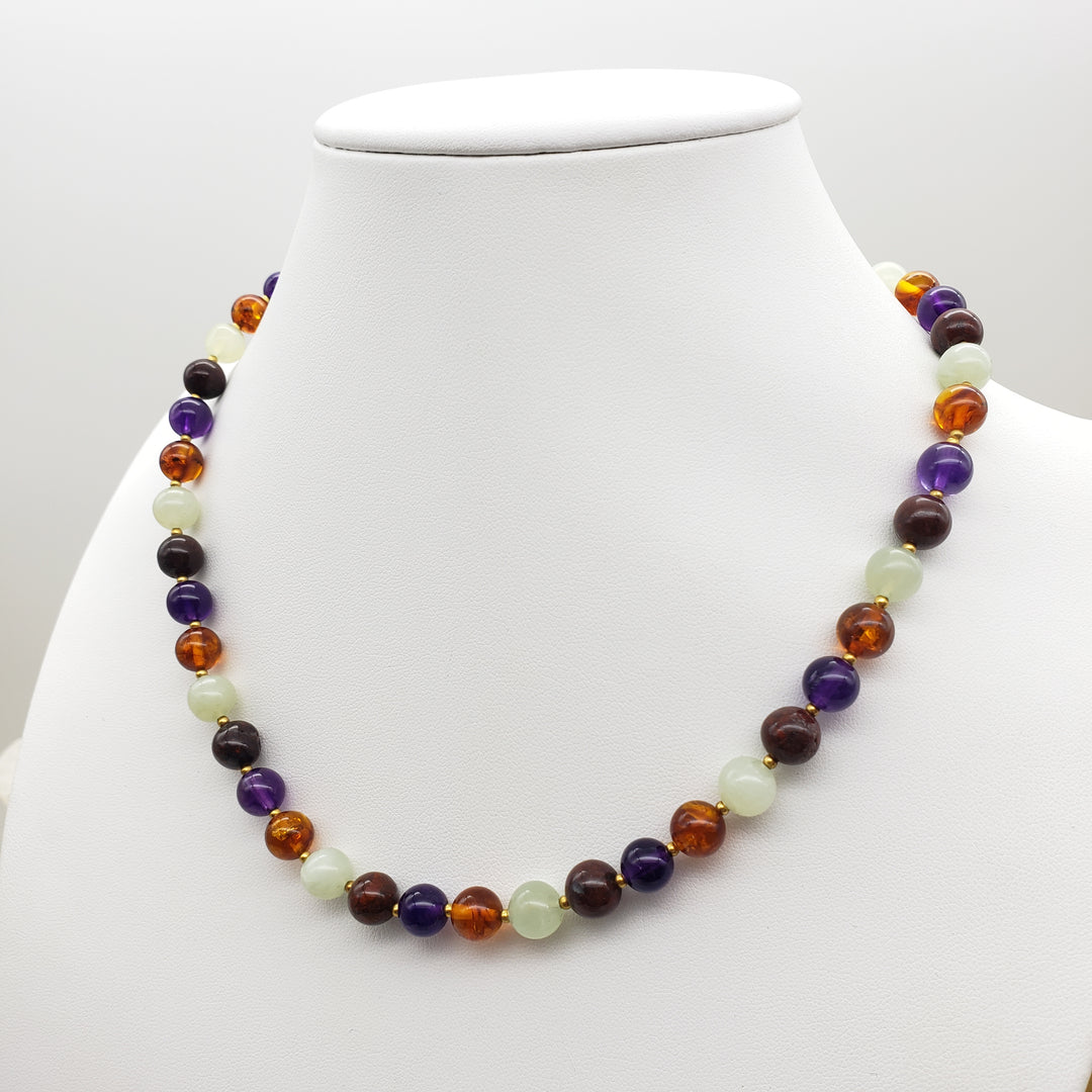 Multicolored beaded necklace on a white mannequin bust