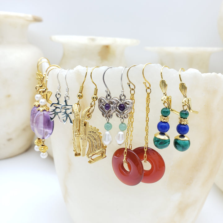 Set of colorful beaded earrings on a shell