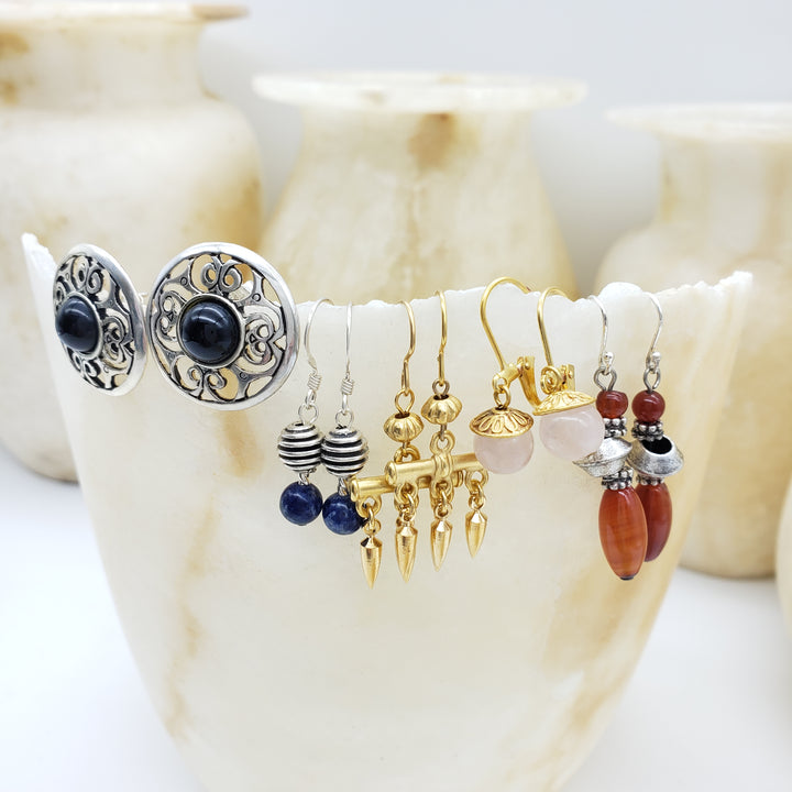 Set of earrings displayed on a shell