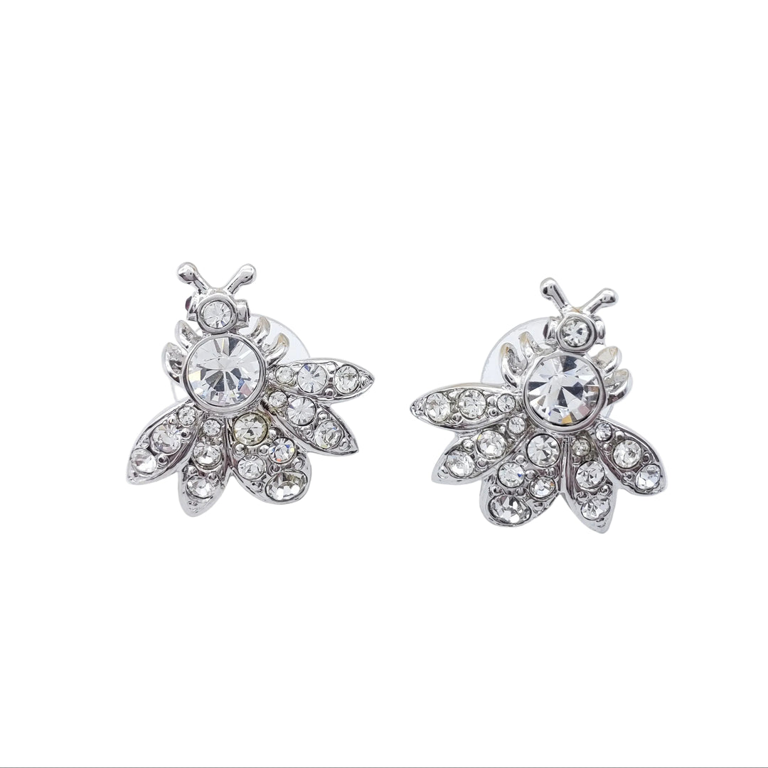 Silver bee-shaped earrings with clear gemstones on a white background