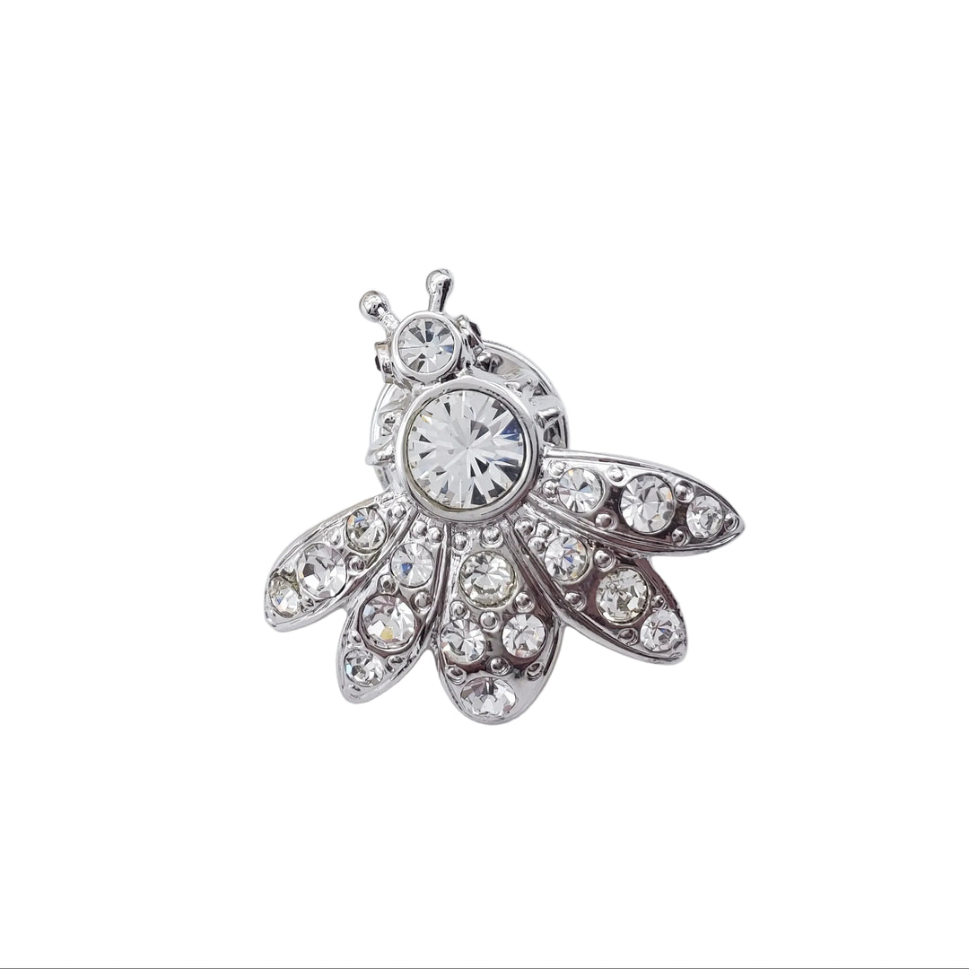 Silver brooch with gemstones on a white background