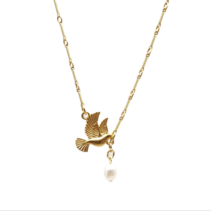 A delicate gold chain necklace featuring a small gold bird pendant and a dangling white pearl, shown against a plain white background.