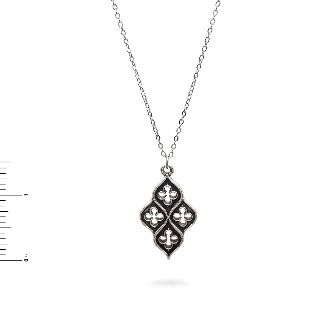 Silver necklace with a decorative pendant on a white background
