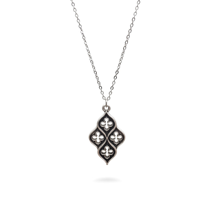 Silver necklace with a decorative pendant on a white background