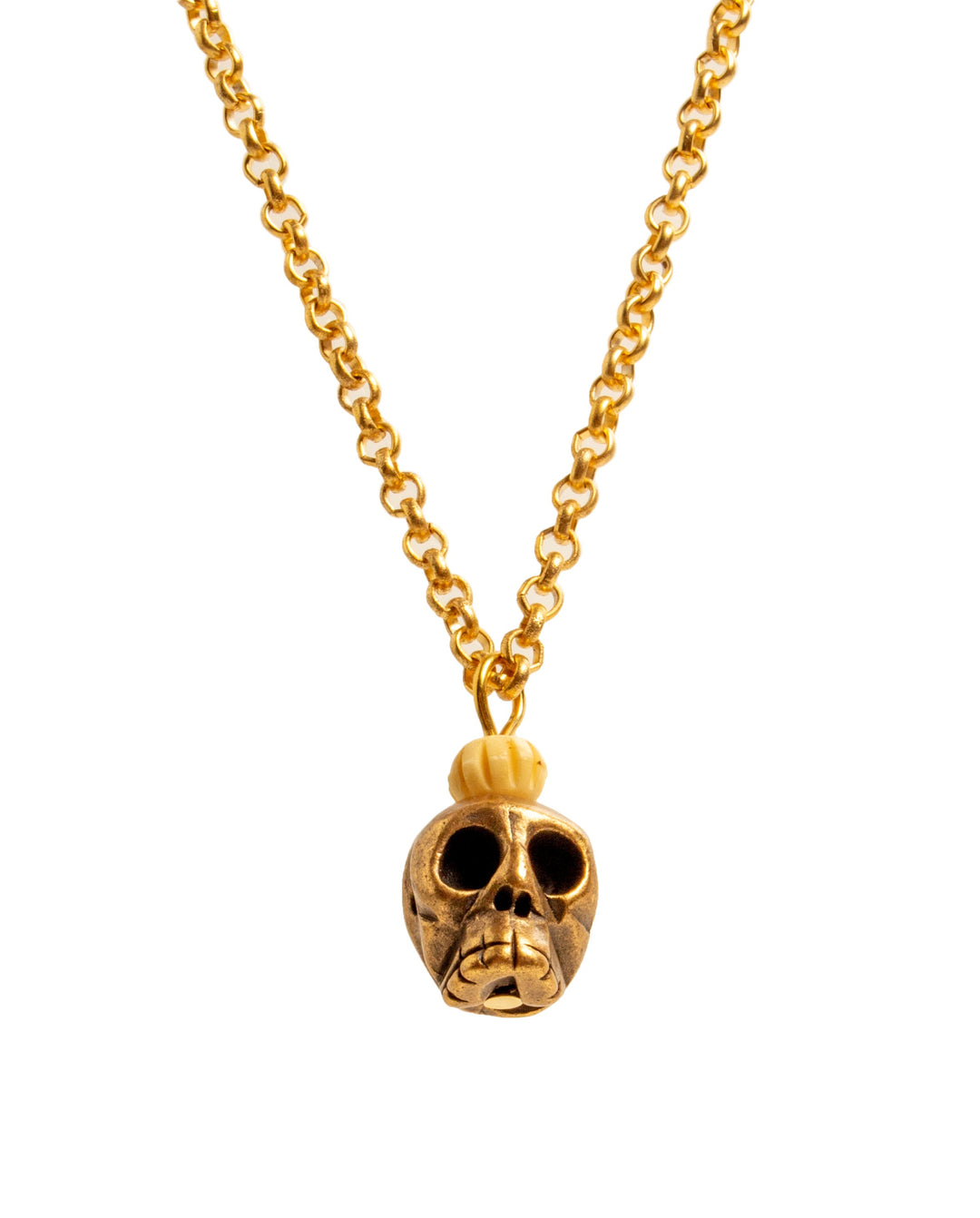 Gold skull pendant necklace on a white background