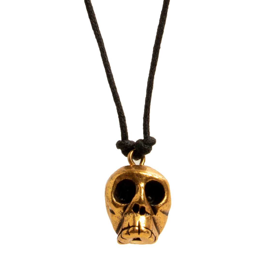 Gold skull pendant on a black cord with wooden beads against a white background