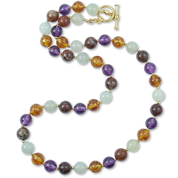 Multicolored beaded necklace with a gold clasp on a white background