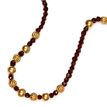 Necklace with red and gold beads on a white background