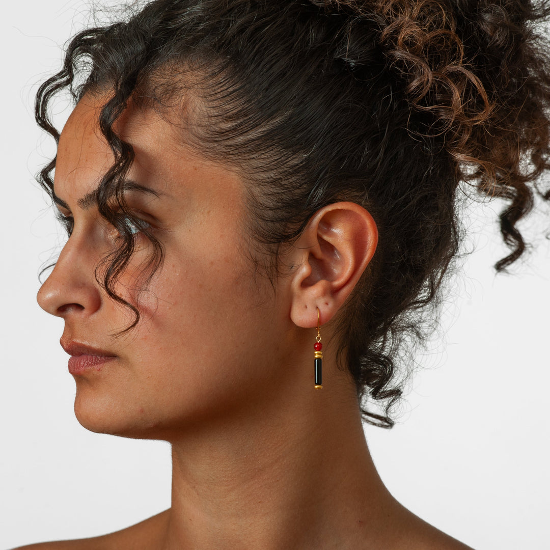 Close-up of a woman's profile with an earring on a white background