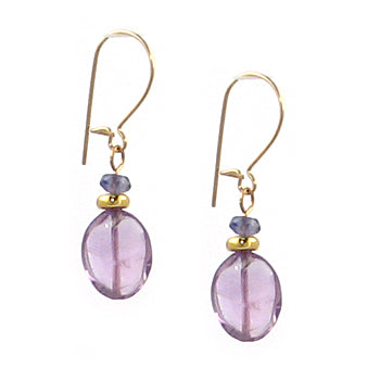 Pair of gold earrings with purple beads on a white background
