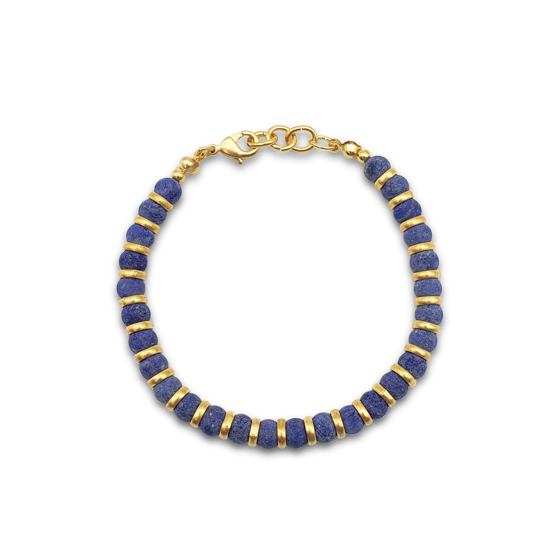 Bracelet with blue beads and gold accents on a white background