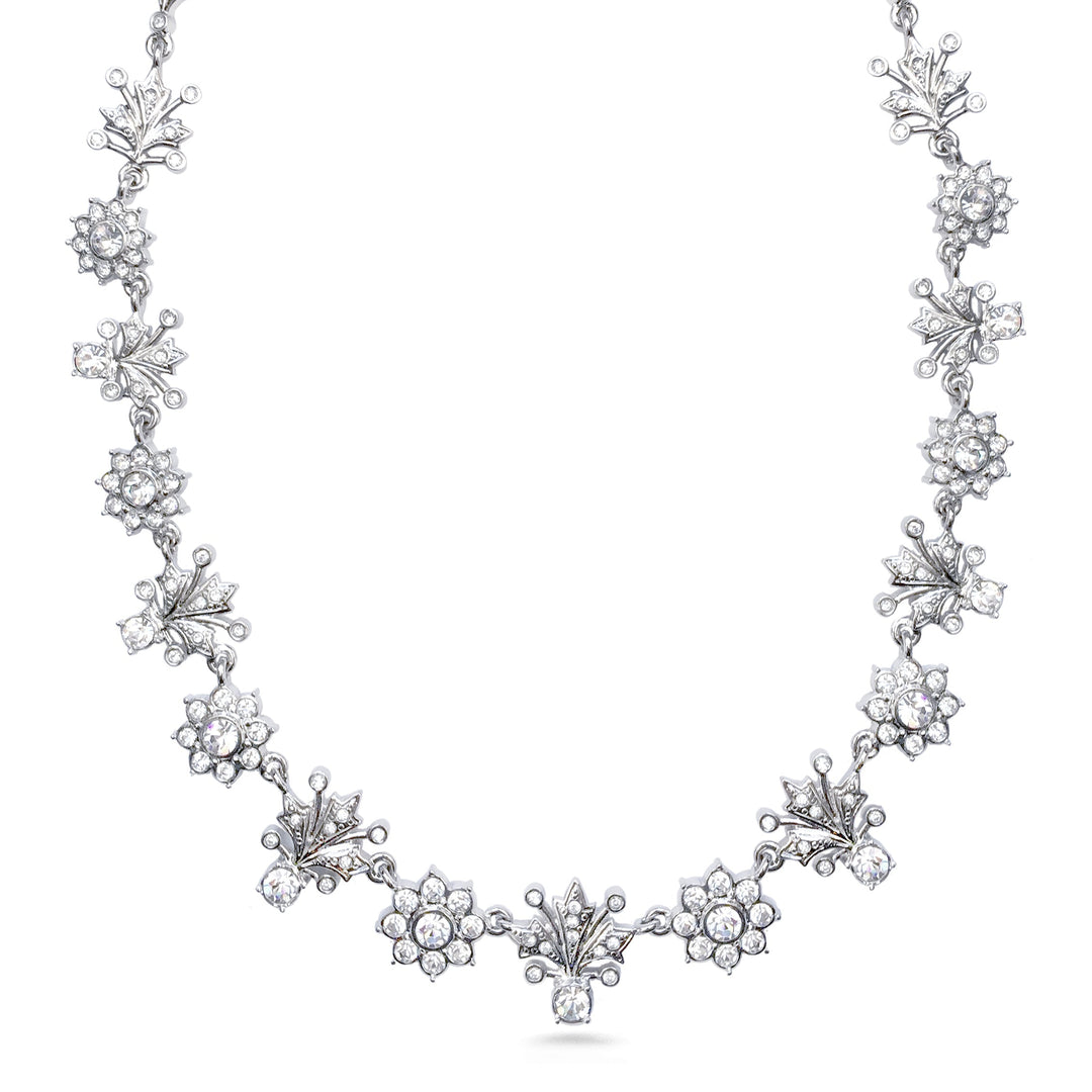 Silver necklace with floral designs on a white background