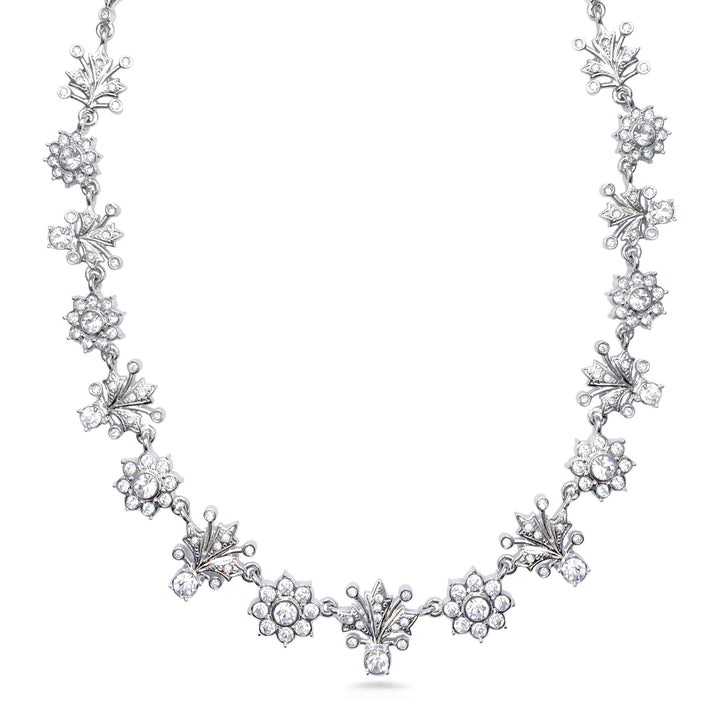 Silver necklace with floral designs on a white background