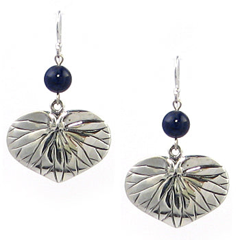 A pair of silver dangle earrings featuring textured, leaf-like heart charms and a small dark blue bead below each charm, shown on a plain white background.