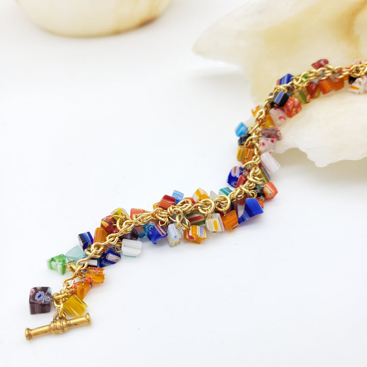 Colorful beaded necklace with gold chain on a white background